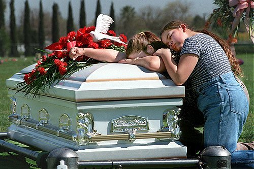 Mother and sister of Nicholaus Contreraz grieve over his casket